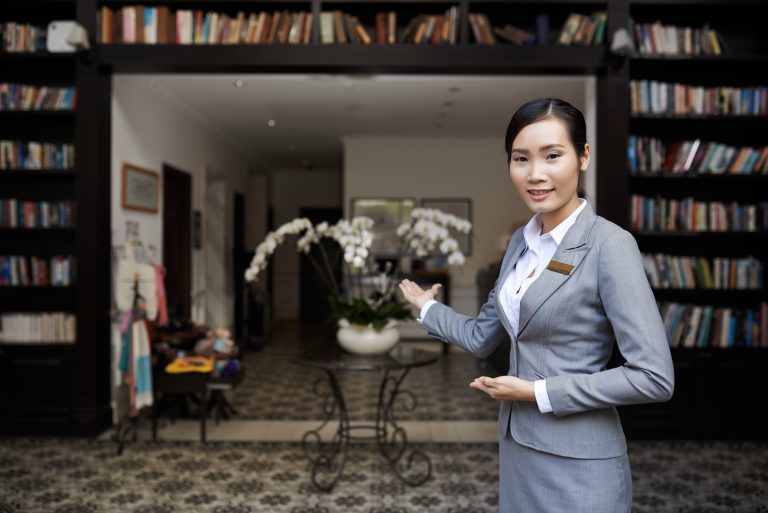 Smiling,Hospitable,Receptionist,Welcoming,You,At,The,Hotel